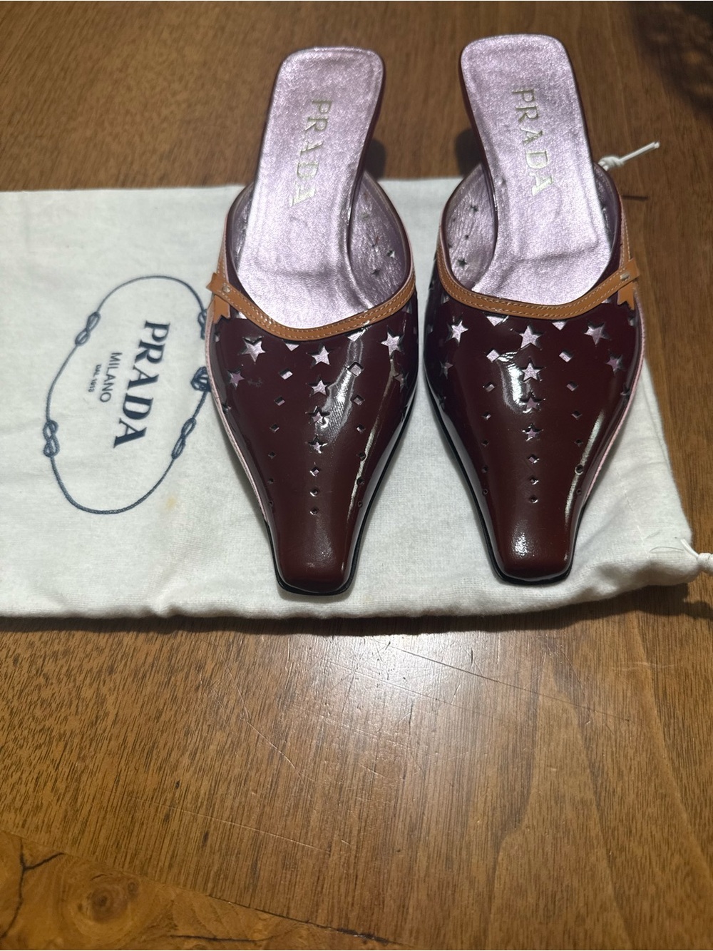 Prada Burgundy Patent Leather Star-Cut Mules with Tan Trim
